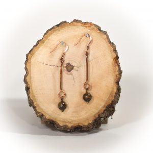 Dangling earrings with tiger's eye beads on wood slice.