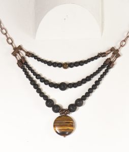 Layered stone necklace with round pendant.