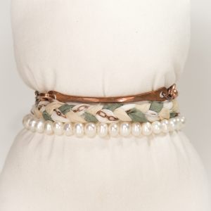 Braided bracelets with pearls on white background