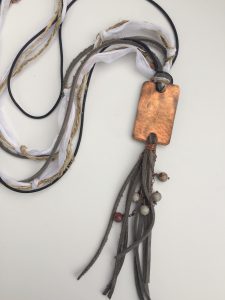 Artisan copper pendant necklace with leather tassels