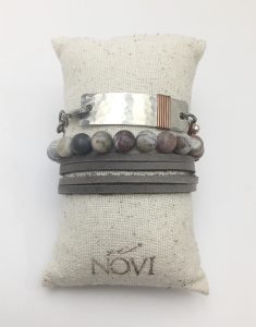 Stylish marble-pattern bracelet on display cushion.