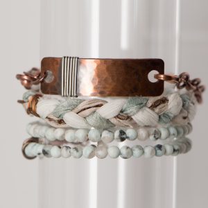 Stacked bracelets with beads and metal detail.