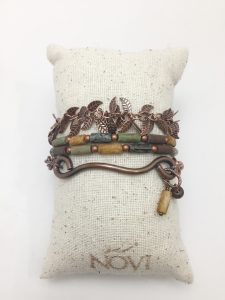 Bronze leaf bracelet on burlap cushion