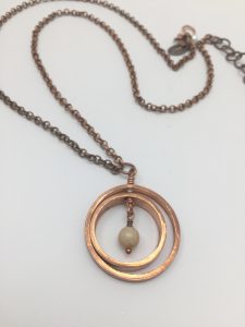 Copper circle pendant necklace with bead accent