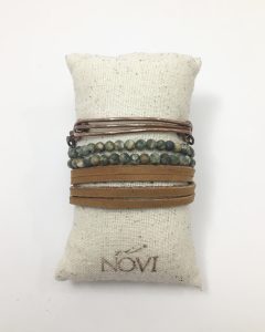 Stacked bracelets on a cushion display
