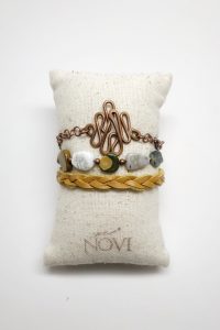 Handcrafted bracelets displayed on fabric pillow