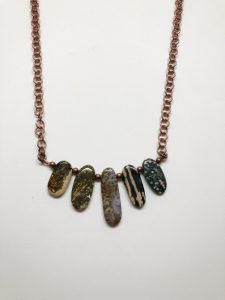 Stone pendant necklace on copper chain.