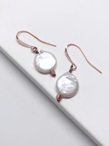 Pearl earrings on a white surface