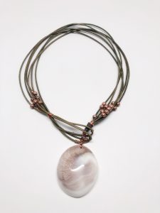 Brown beaded pendant necklace with stone charm.
