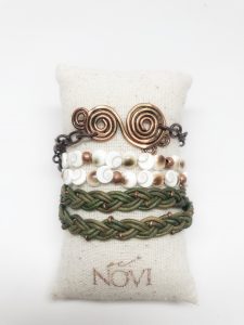 Handcrafted bracelets on display pillow