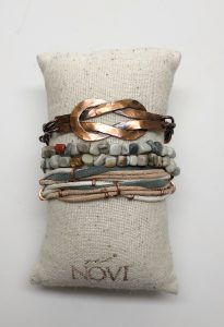 Handmade bracelet stack on cream textured pillow