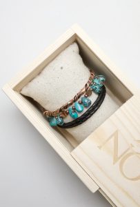 Turquoise and copper bracelets in wooden box