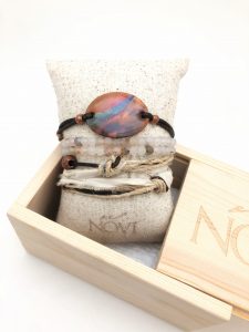 Colorful bracelet with leather ties in wooden box.