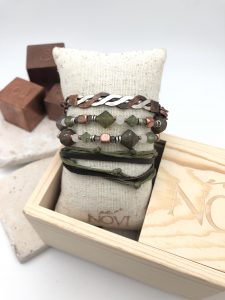 Handcrafted bracelets on display with wooden box