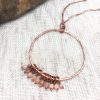 Copper necklace with stone beads on display.