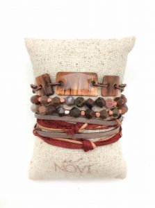 Stacked bracelets on a fabric cushion