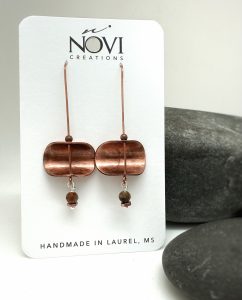 Copper earrings on display card, handmade in Laurel, MS.