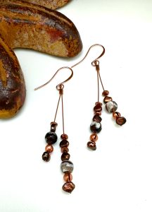 Copper and glass bead dangle earrings with stone decor.