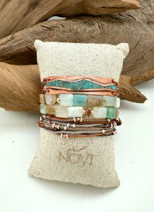 Handmade beaded bracelets on display pillow.